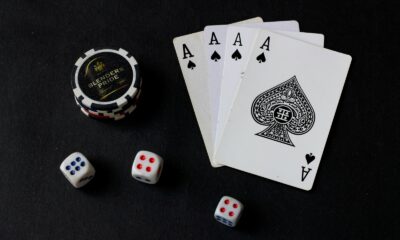 playing cards and dice on a black table